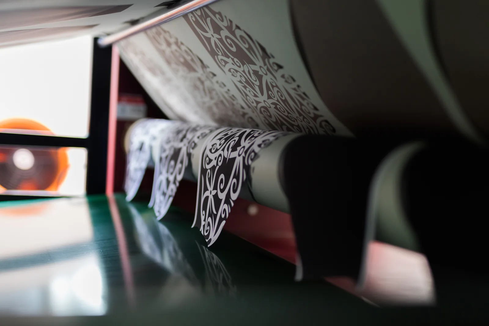 Printed graphics emerging from production equipment